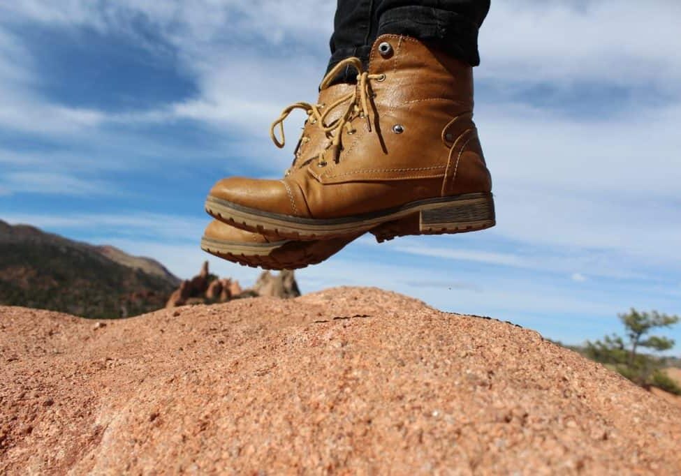 close up of boots jumping in the desert